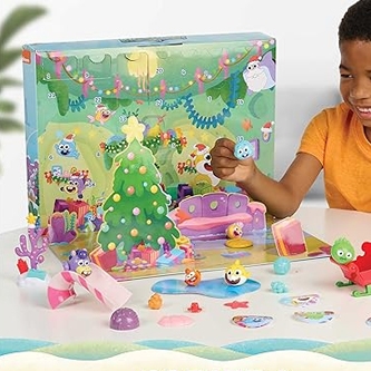 A child is playing with a colorful board game featuring a Christmas tree and various whimsical characters.