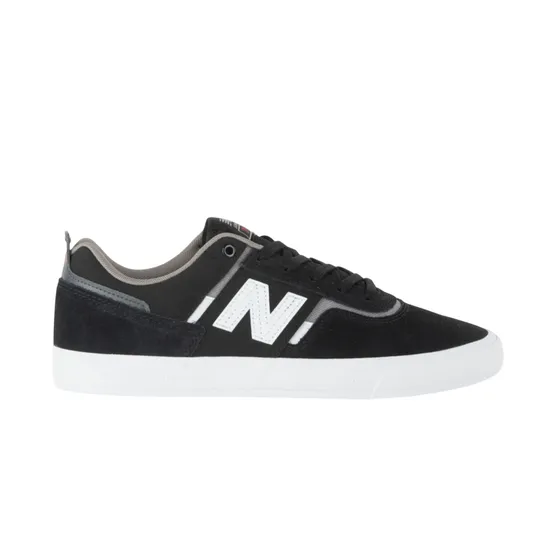 A black and white New Balance sneaker featuring a prominent \“N\“ logo, black suede overlays, and a white sole.