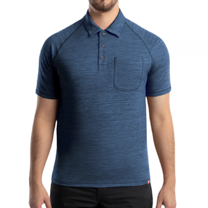 A blue short-sleeve polo shirt with a textured fabric, buttoned collar, and a small chest pocket, worn by a model with black pants.
