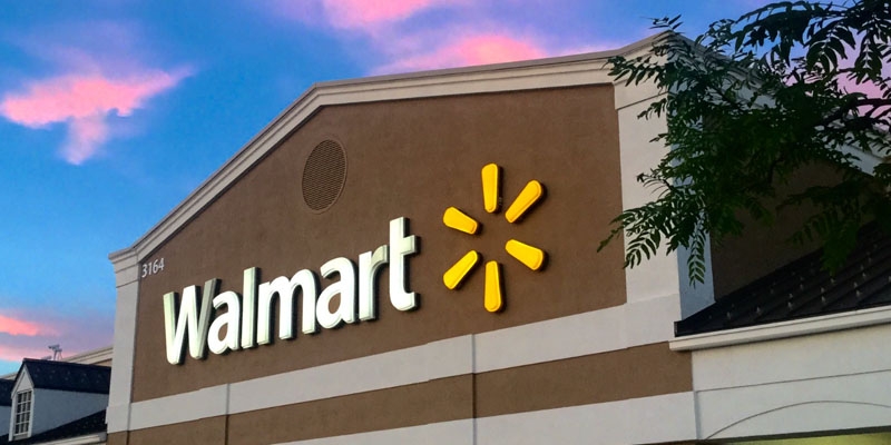 a walmart store in front of a blue and pink sunset