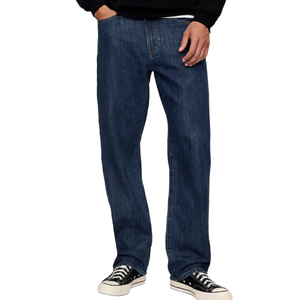 Dark blue straight-leg jeans paired with black and white low-top sneakers.