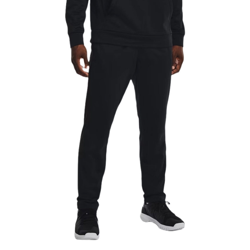 A person is wearing a black hoodie and black jogger pants, paired with black and white sneakers.