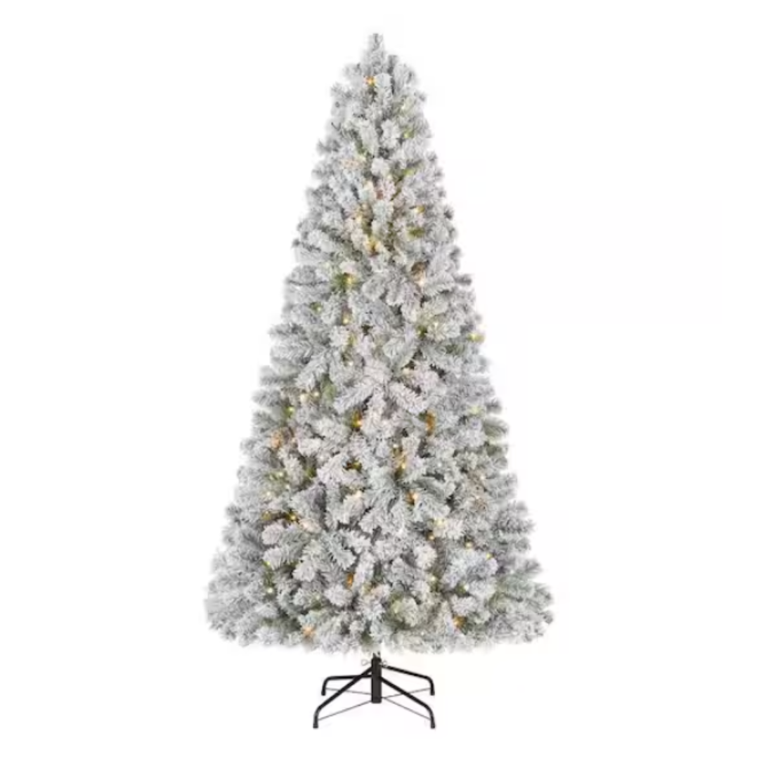 A frosted artificial Christmas tree with a full, conical shape, featuring pre-lit warm white lights and a sturdy metal stand.