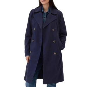 A person wearing a navy blue double-breasted trench coat over a patterned shirt and jeans.