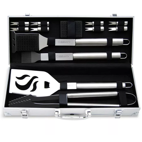 A barbecue tool set in a silver case includes a spatula, tongs, basting brush, grill brush, skewers, and corn holders. All tools have stainless steel handles and are neatly organized within the case.