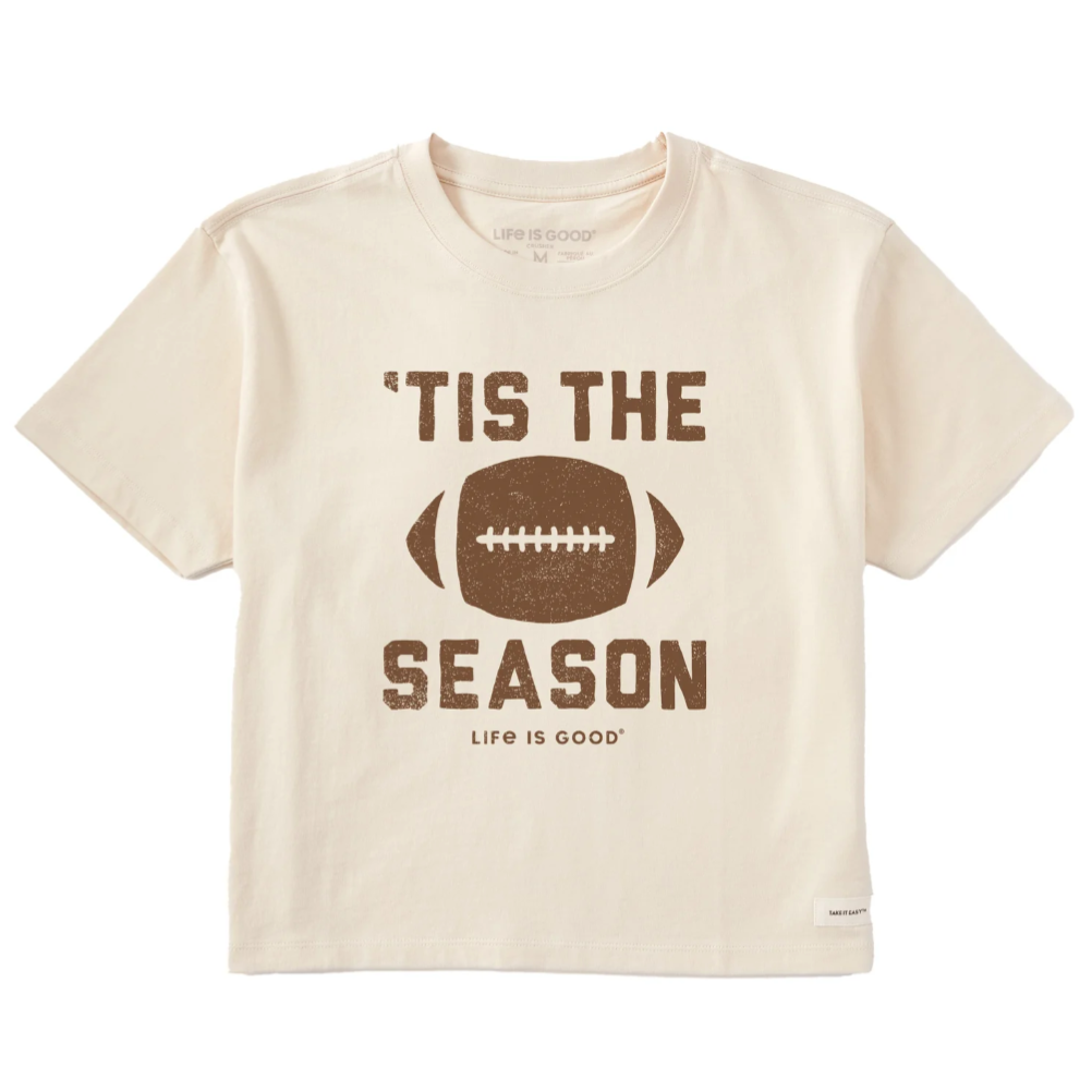 Cream-colored T-shirt featuring a football graphic with the text \“'Tis the Season\“ and \“Life Is Good\“ underneath.