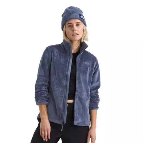A person wears a blue fleece jacket and a matching blue beanie.