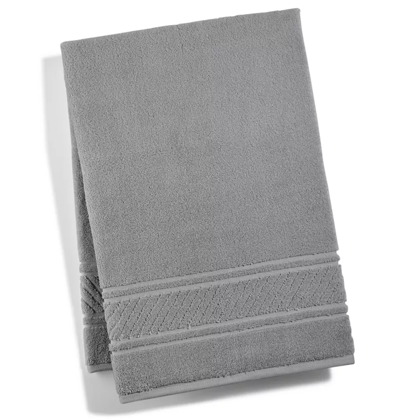 Gray bath towels with decorative borders, stacked.