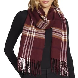 A woman wearing a burgundy plaid scarf with fringe over a black top.