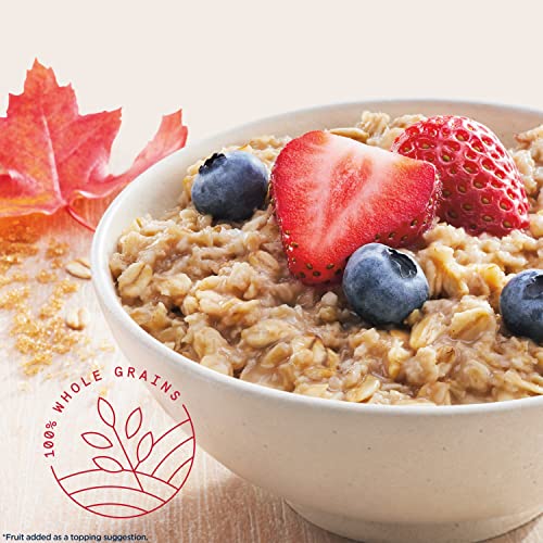 A bowl of oatmeal with maple brown sugar flavor is topped with strawberries and blueberries, suggesting a serving suggestion for Quaker Oats.