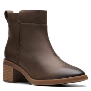 Brown leather ankle boot with a block heel and pull-tab, featuring a smooth, rounded toe and stitched detailing.