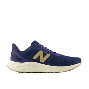 New Balance Fresh Foam Arishi shoes in navy blue feature a gold \“N\“ logo, mesh upper for breathability, and a cushioned white sole for comfort and support.