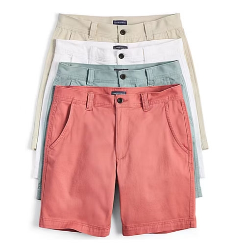 St. John's Bay Chino Shorts are available in four colors: coral, sage green, white, and khaki. They feature a button closure, belt loops, and side pockets for a classic style.