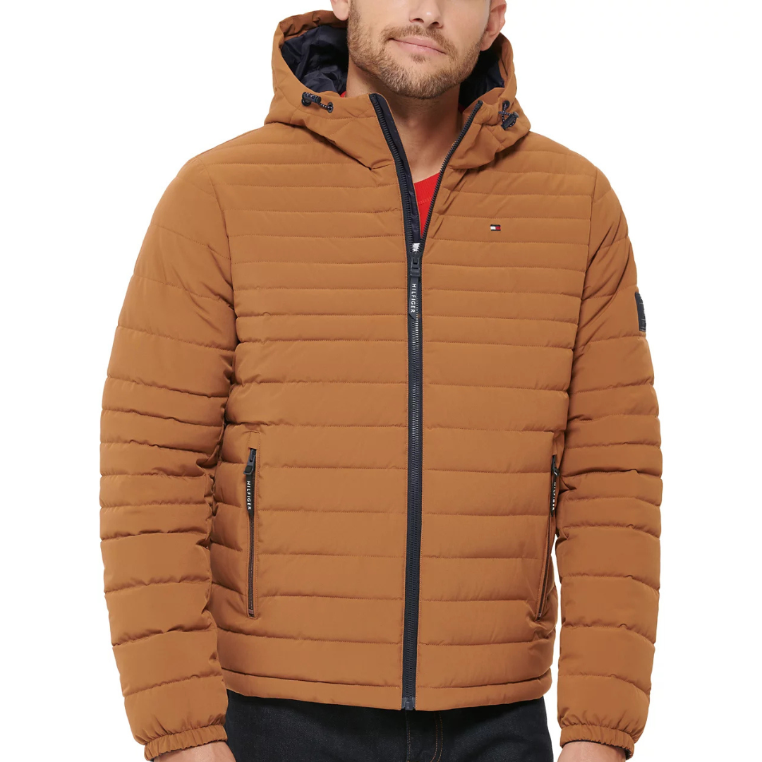 Brown quilted hooded jacket with a front zipper and two zippered pockets. Features elastic cuffs and a small Tommy Hilfiger logo on the chest.