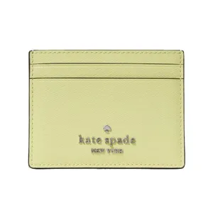 A light green Kate Spade cardholder with multiple slots and the brand's logo on the front.