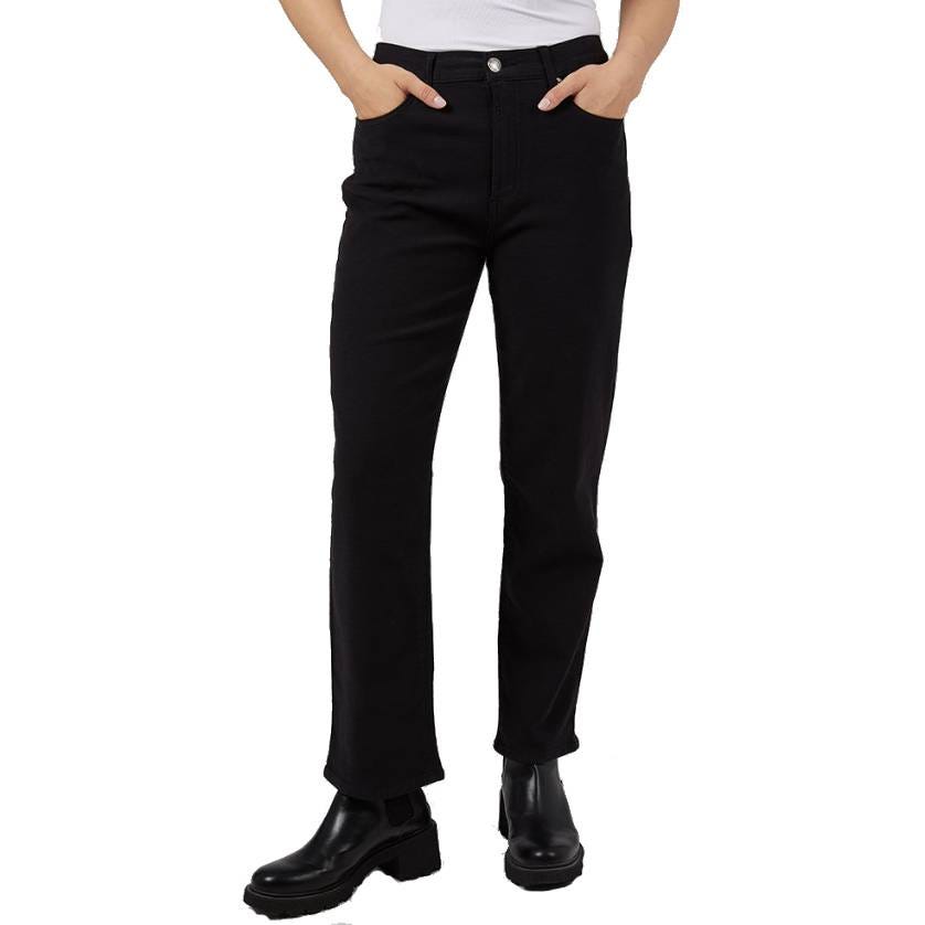Black straight-leg jeans with a high-rise waist, featuring front and back pockets, and paired with chunky black ankle boots.