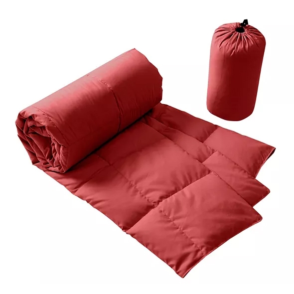 Red oversized down throw with square quilting, accompanied by a cylindrical matching storage bag.