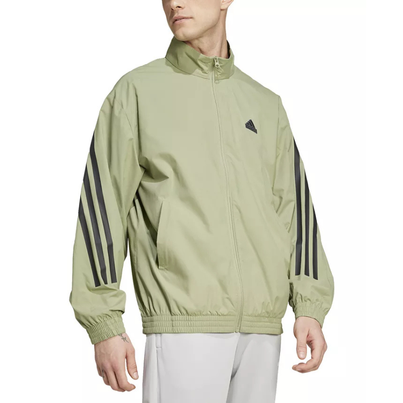 Light green Adidas track jacket with black three-stripe design on the sleeves and a small logo on the chest. Features a full zip front, a high collar, and elastic cuffs and hem.