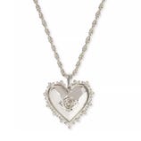 Silver heart-shaped pendant with a rose design in the center, surrounded by a decorative border, hanging from a twisted rope chain.