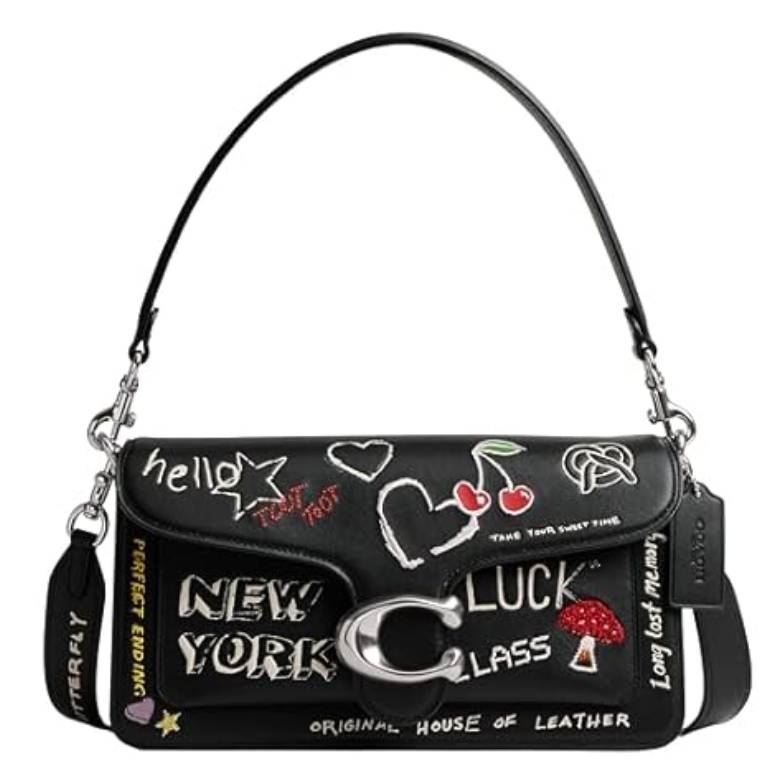 Black shoulder bag with various embroidered designs, including words like \“New York,\“ a cherry, a heart, and a mushroom. Features a prominent silver \“C\“ clasp and a detachable strap with chain details.