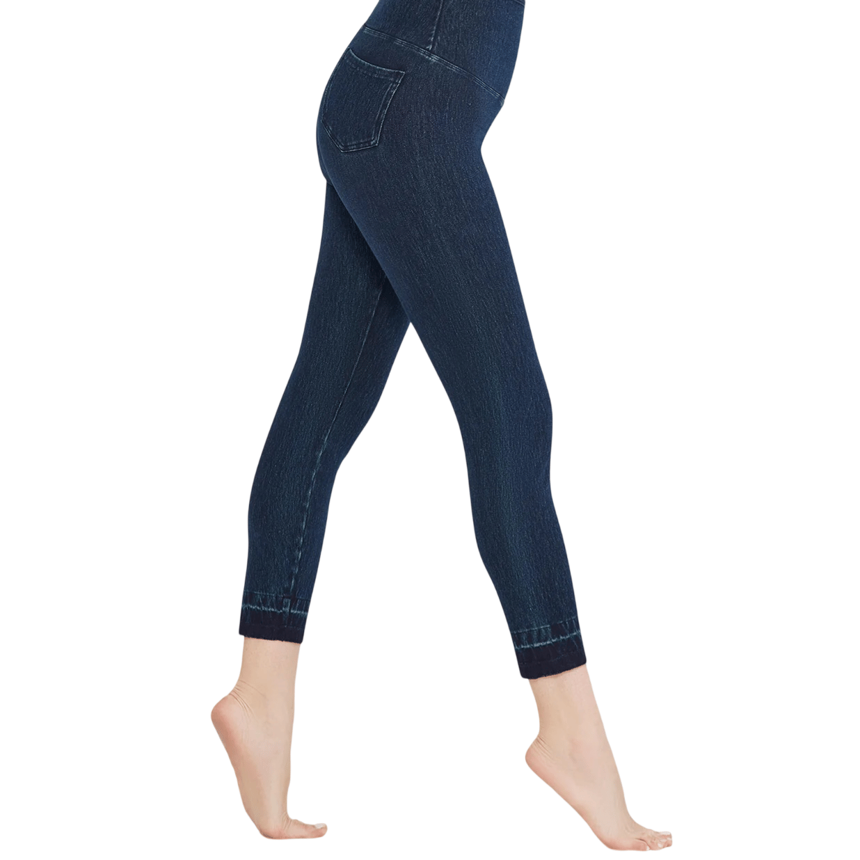 A pair of dark blue jeggings with a high-waisted fit, featuring denim-like appearance and a back pocket detail, shown in a side view.
