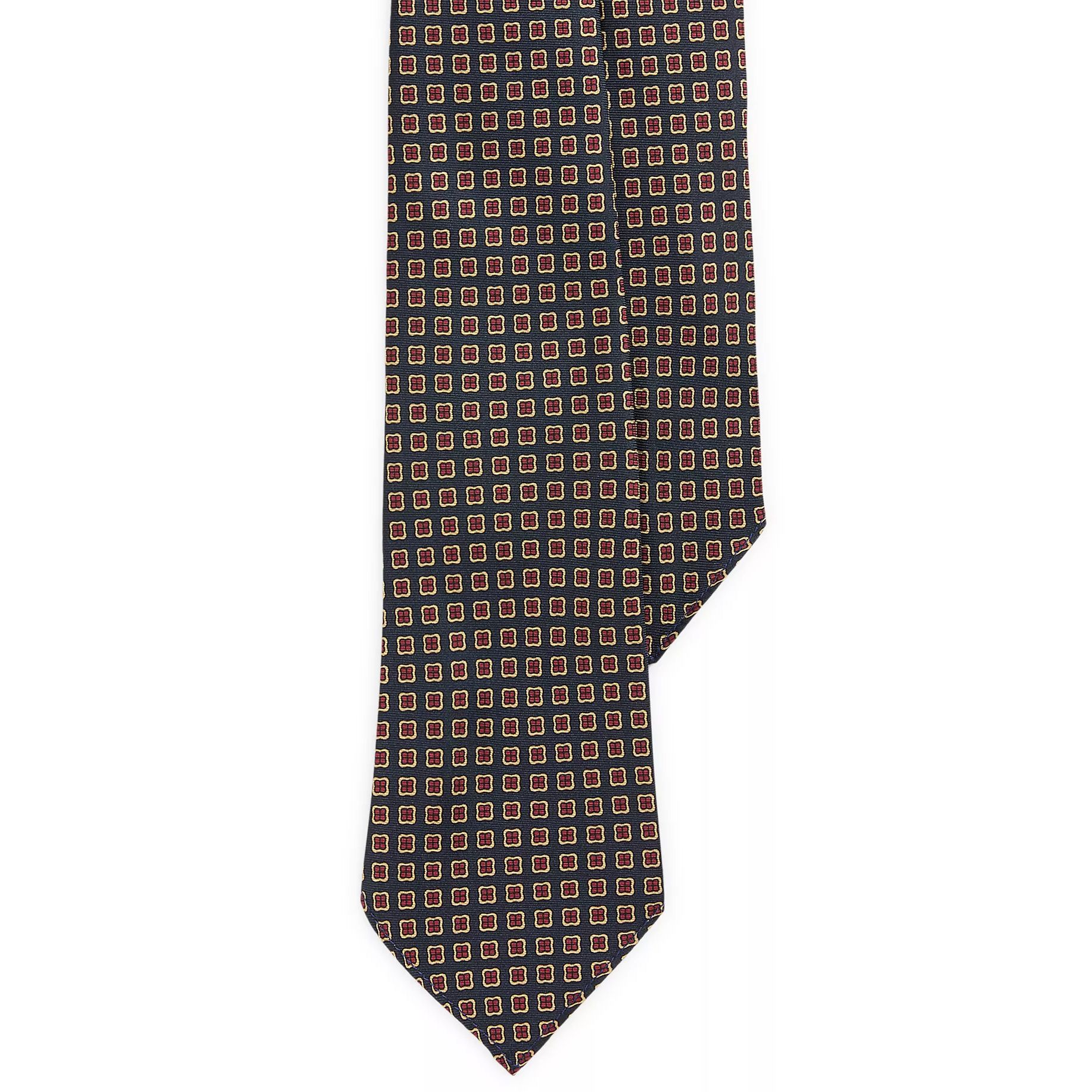 A tie featuring a repeating pattern of small red and yellow squares on a dark background.