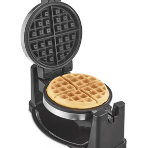A black flip-style waffle maker with a round, cooked waffle inside.