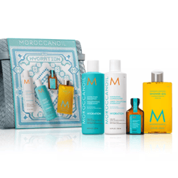 Moroccanoil Hydration set includes Hydrating Shampoo (250 ml), Conditioner (250 ml), Shower Gel (250 ml), and a treatment oil. Comes with a patterned bag.