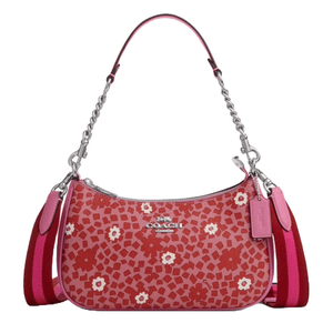 A Coach shoulder bag featuring a pink and red floral pattern with a detachable striped strap, chain detailing, and a Coach logo tag.