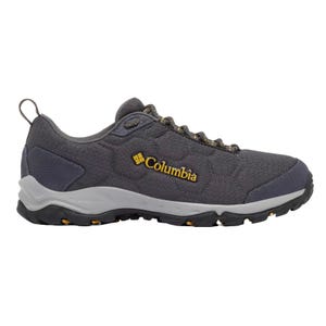 Columbia hiking shoe in dark gray with a textured fabric, featuring a yellow logo, sturdy sole with orange accents, and heel loop for easy handling.