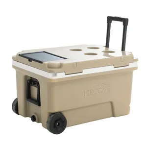 A tan-colored cooler with wheels, an extendable handle, and cup holders on the lid.