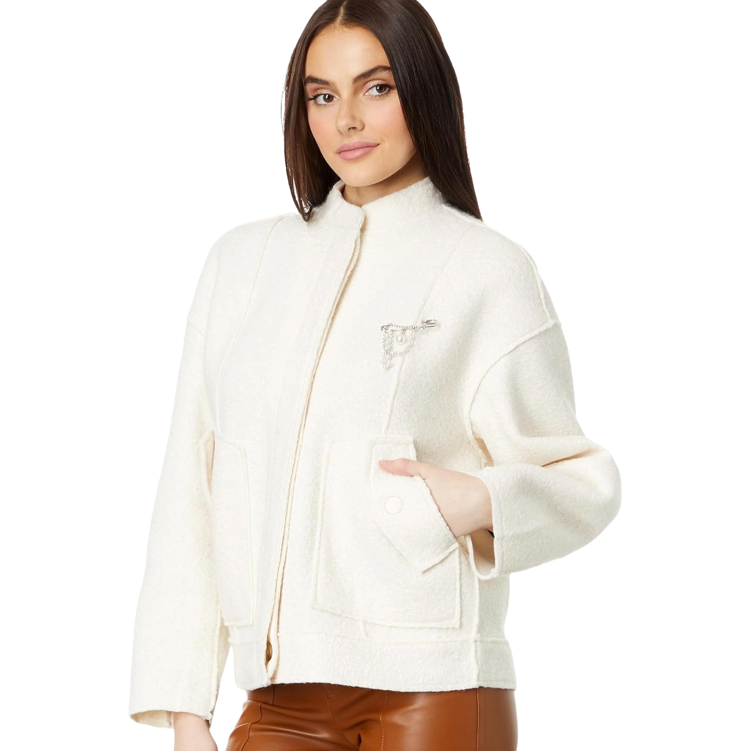 A white Free People bomber jacket with a collarless design, subtle texture, and a zipper closure. It features two front pockets and a decorative chain detail on the chest, paired with brown leather pants.