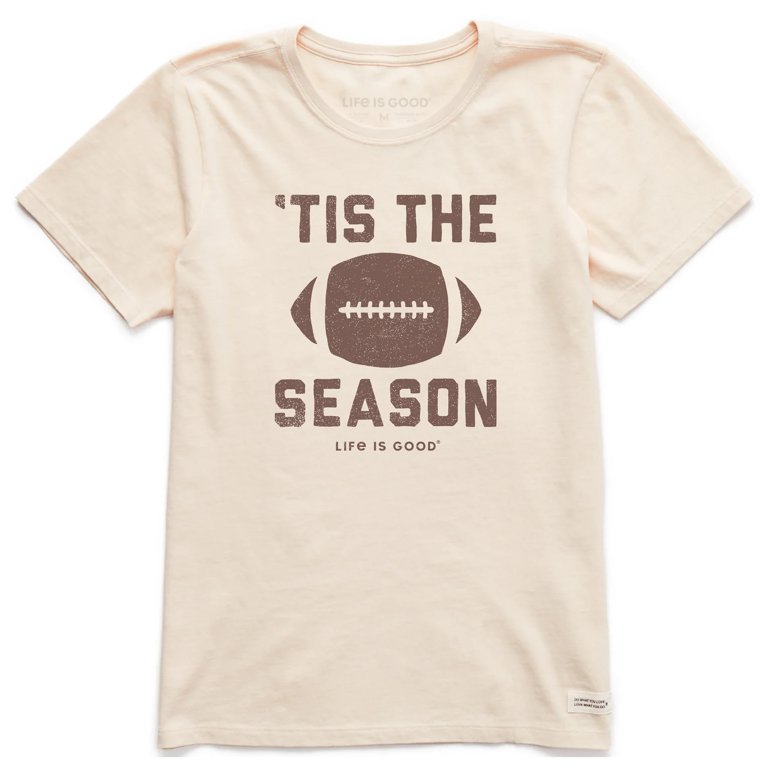A beige T-shirt features a graphic of a football with the text \“'Tis the Season\“ and \“Life is Good\“ beneath it.