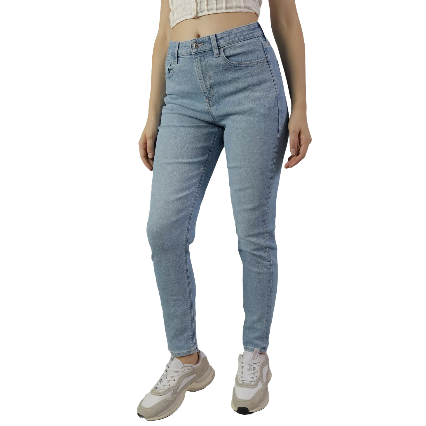 A person is wearing light blue denim mom jeans with a high waist and slim, tapered legs, paired with white sneakers.