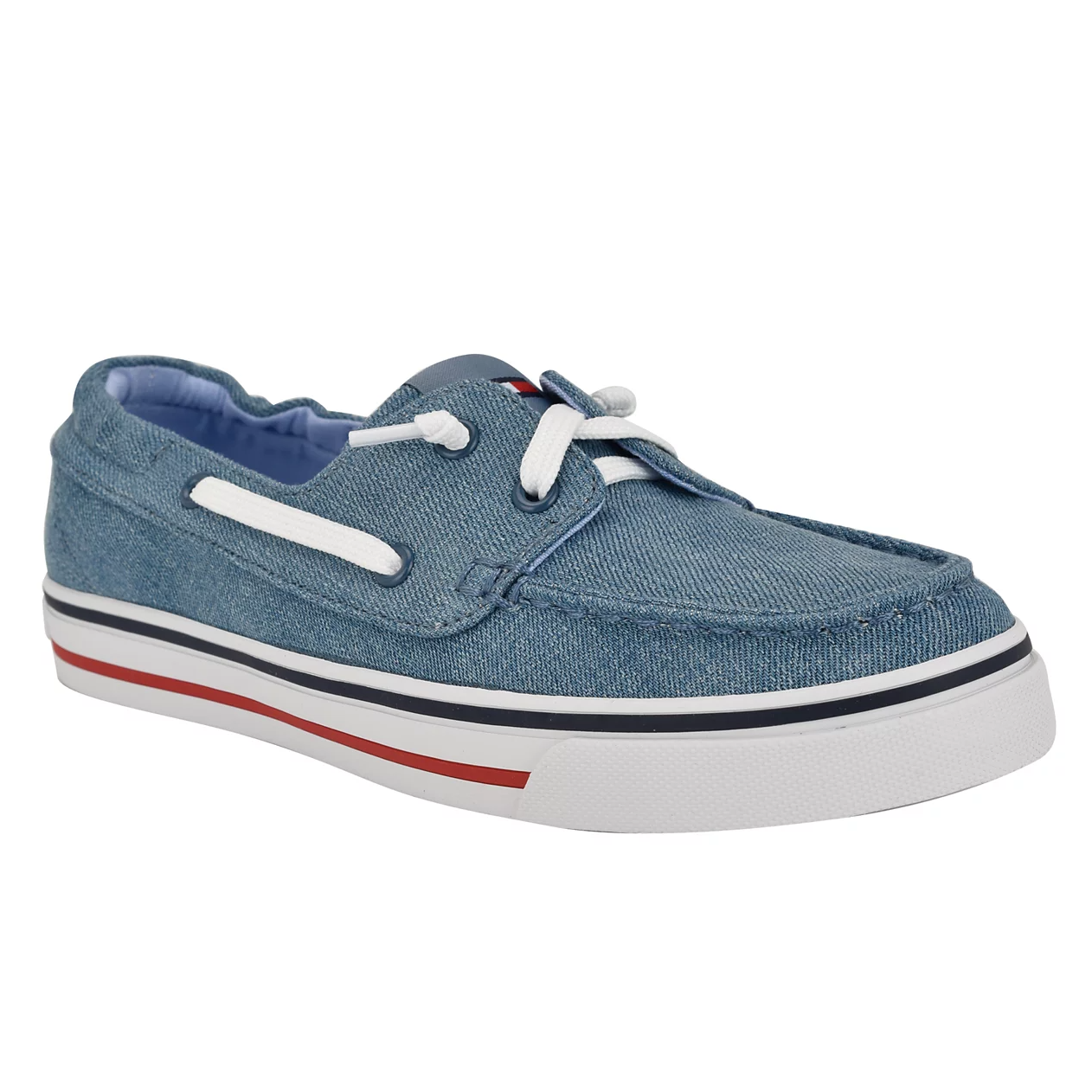 Tommy Hilfiger Women's Boat Shoes feature a blue denim exterior, white laces, and eyelets. They have a white sole with a red and blue stripe, providing a classic, nautical look.