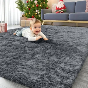 A gray, 4' x 6' shag rug is on the floor in a living room with a baby playfully lying on it, and there's a Christmas-themed setup with a tree, presents, and Santa decoration nearby.