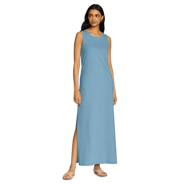 Sleeveless blue maxi dress with side slit, worn with flat sandals.