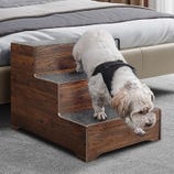 A three-step wooden pet stair with carpeted treads for traction, designed to help pets reach elevated areas.