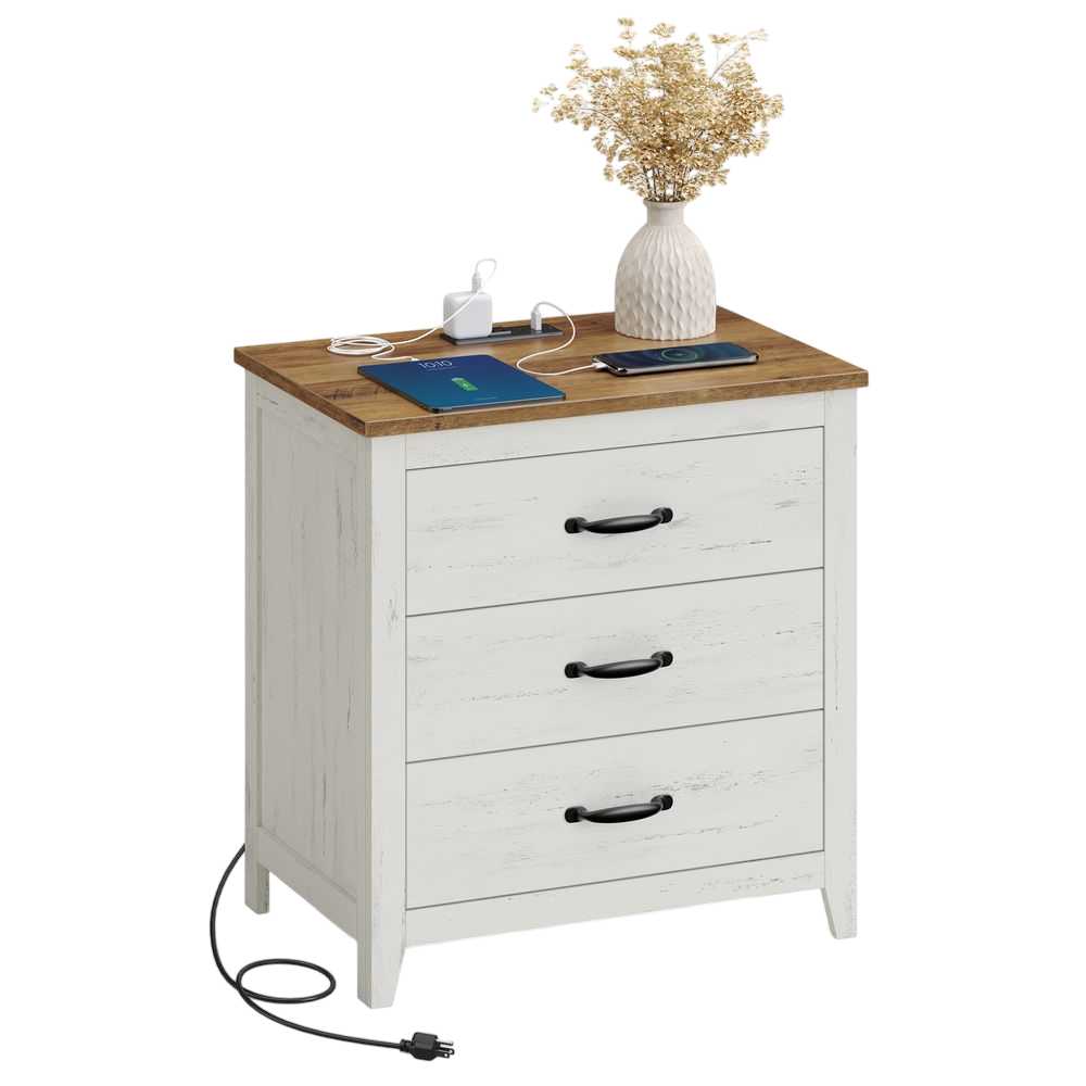 White wooden nightstand with three drawers, featuring a brown tabletop, black handles, and a built-in charging station. Decorated with a vase of dried flowers, a phone, and a charging tablet.