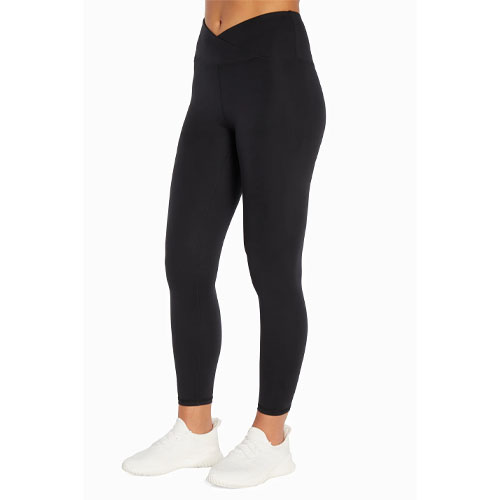 Black leggings with a high-waist and crossover waistband, paired with white sneakers.