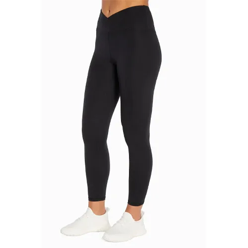 Black leggings with a high-waist and crossover waistband, paired with white sneakers.