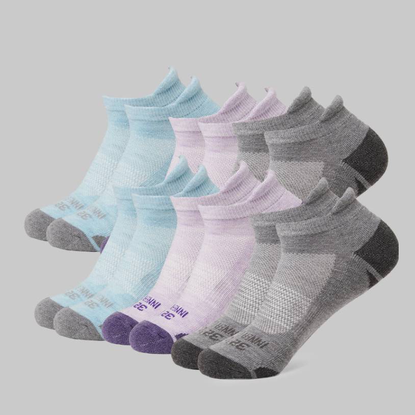 Six pairs of ankle socks in shades of blue, purple, and gray, with reinforced heel and toe regions.