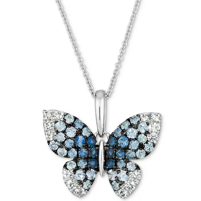 A butterfly-shaped pendant with sparkling blue and white stones, set on a silver chain necklace.