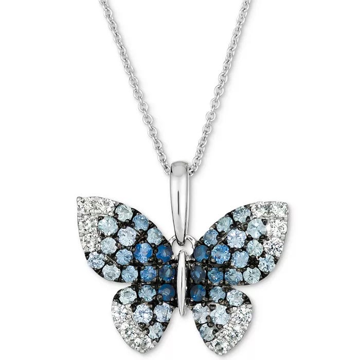 A butterfly-shaped pendant with sparkling blue and white stones, set on a silver chain necklace.