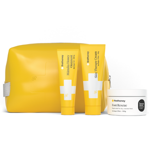 Yellow bag with First Honey products: Manuka Honey Ointment, Skin Therapy Cream, and Foot Rescue, for skin care and foot relief.