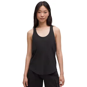 A woman is wearing a black sleeveless tank top with a scoop neck and black cargo pants.