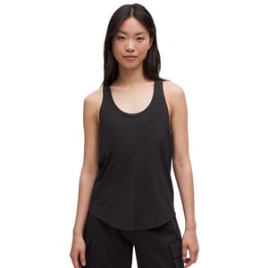 A woman is wearing a black sleeveless tank top with a scoop neck and black cargo pants.
