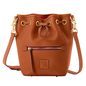 A brown Dooney & Bourke Italian leather bucket bag features a drawstring closure, gold-tone hardware, front zipper pocket, and adjustable shoulder strap, with a small embossed logo patch on the front.