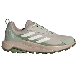 Green and beige Adidas Terrex trail running shoe with white stripes and textured sole.