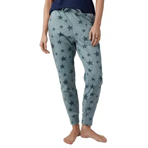 Gray jogger pants featuring a dark star pattern and drawstring waist, modeled with a barefoot person.